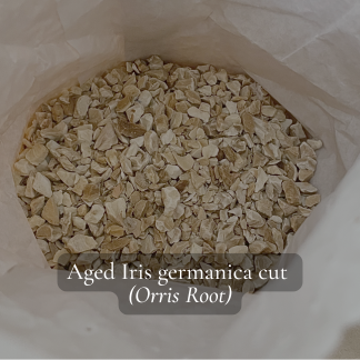 Aged orris root chips on white background, Iris germanica – natural perfumery ingredient